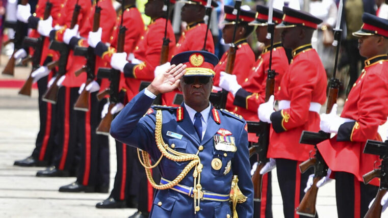 WILLIAN OGOLLA OBSERVING A GUARD OF HONOUR.